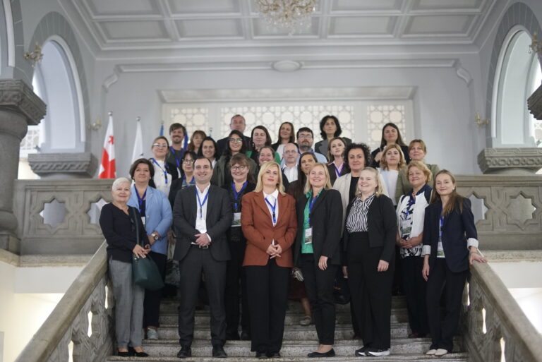 group photo of project consortium standing on the stairs of Caucasus University