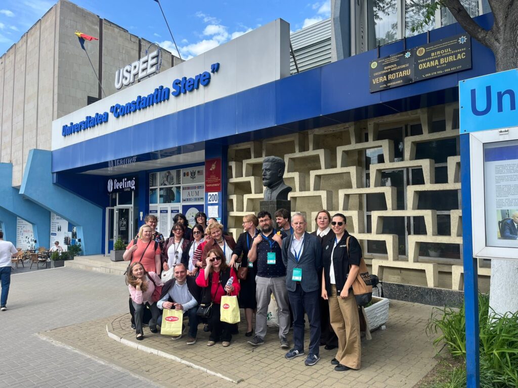 Project team in group photo in frotn of USPEE university